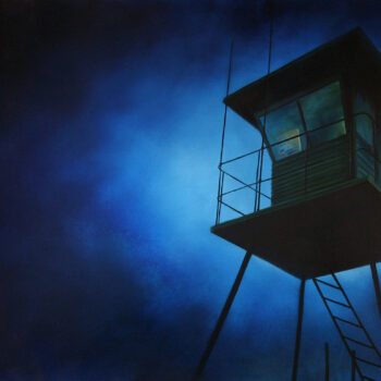 Lifeguard hut in front of deep blue sky.