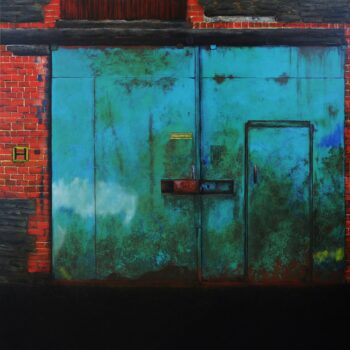 Green metal workshop doors in a red brick wall