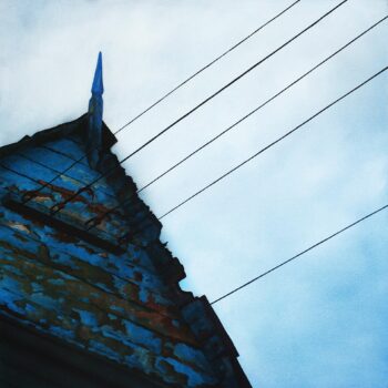 Weathered wooden shed with telegraph wires.