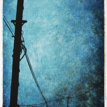 Telephone pole against evening sky.