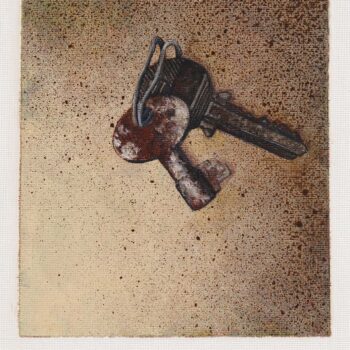 A pair of keys held together by a piece of wire